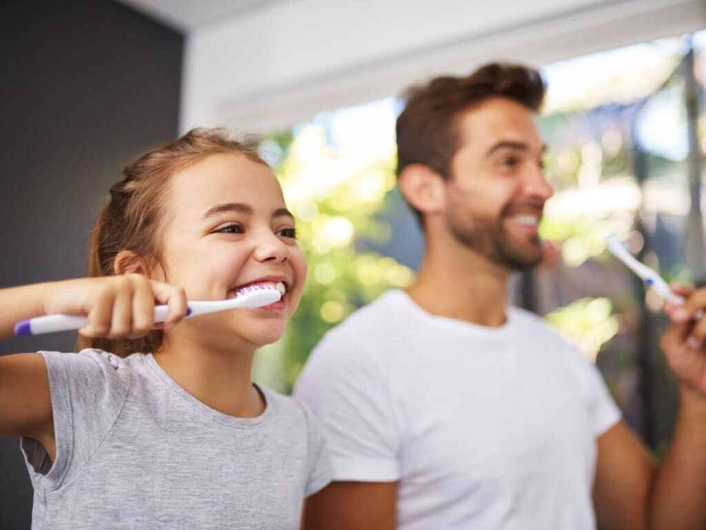 Dad daughter brushing teeth - Dentist Fairview