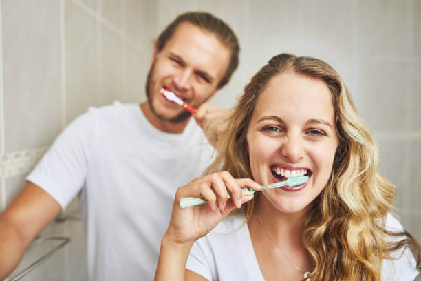 Woman Man brushing teeth
